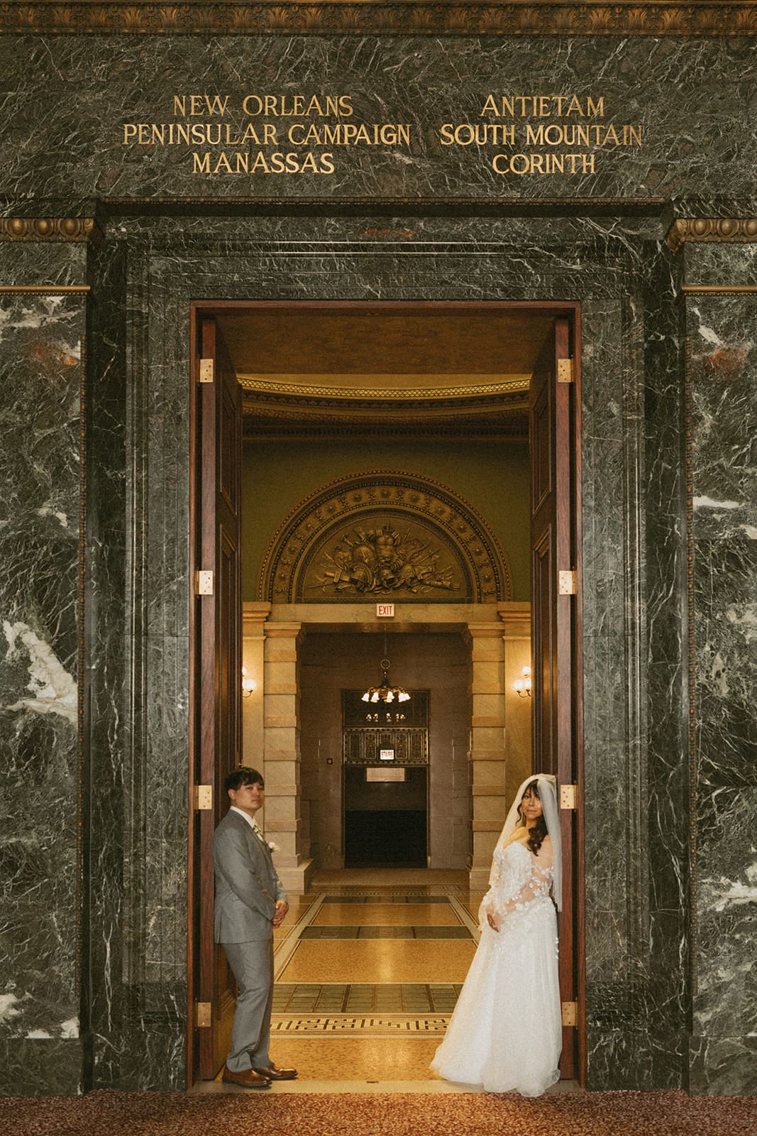 A bride and groom taking courthouse wedding photos