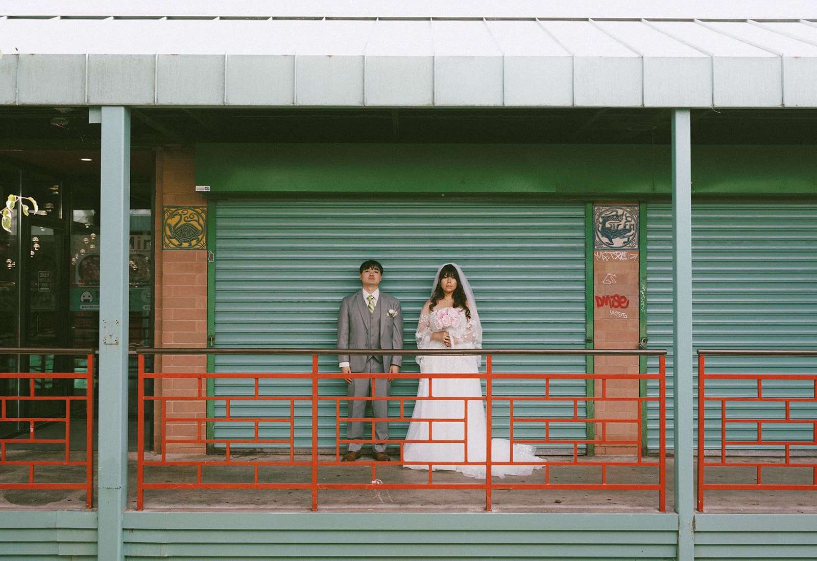 A couple posing in Chinatown for wedding photos