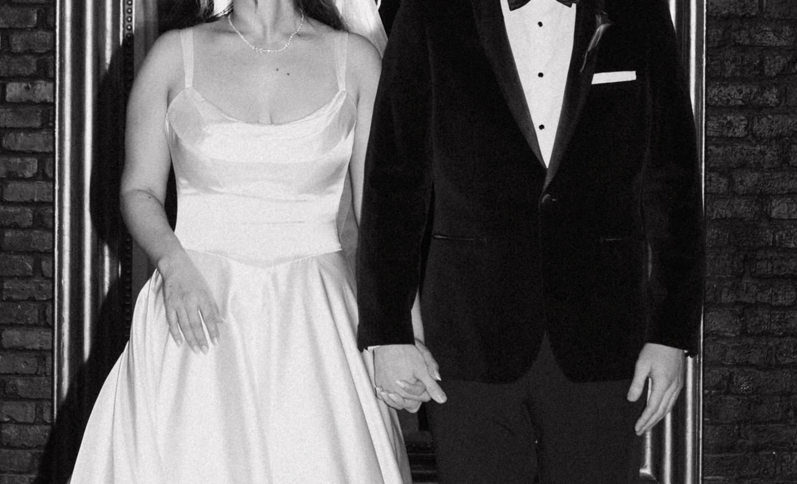 A bride and groom holding hands in a wedding photo