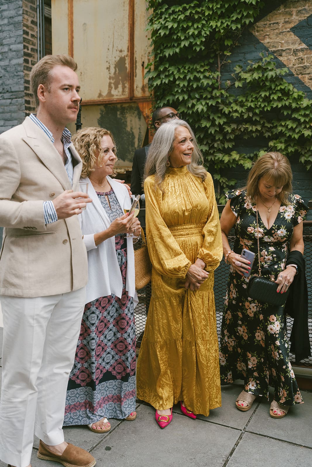 A photo showing off the 2027 wedding trend of maximalist wedding guest outfits
