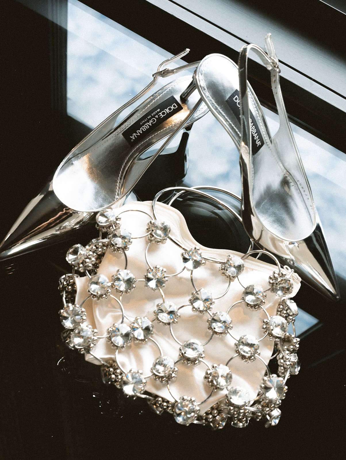 A bride's silver wedding shoes and purse