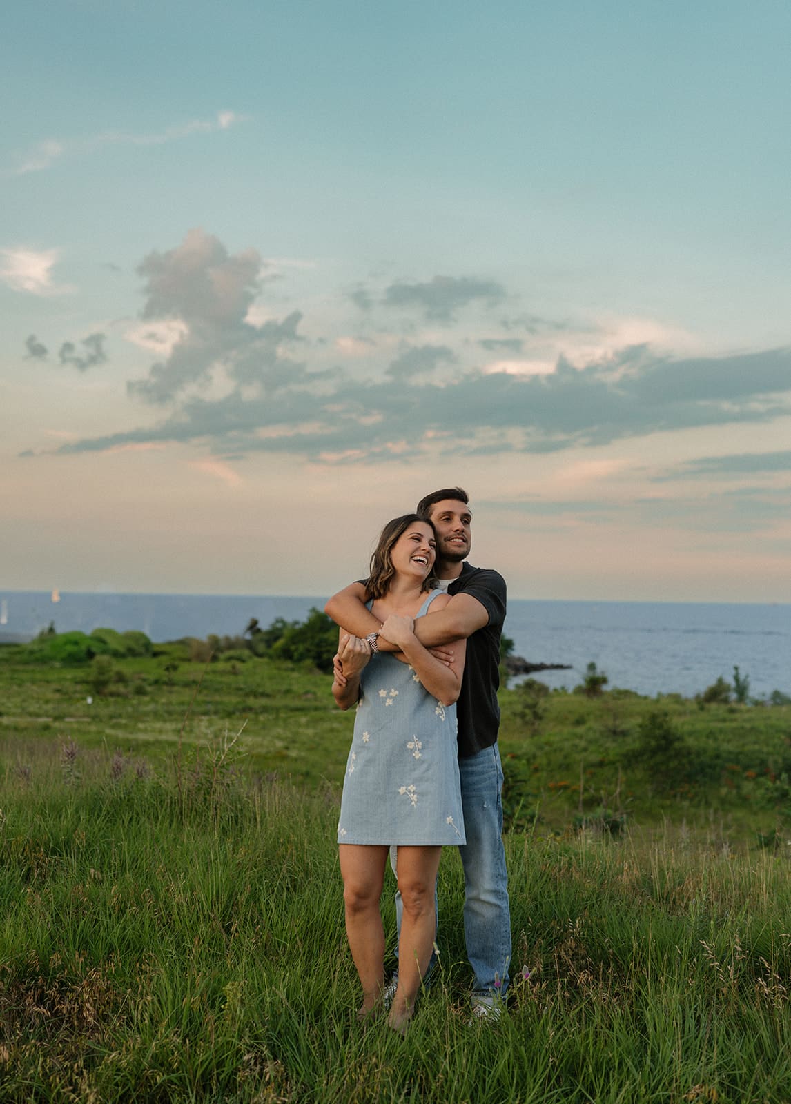 A couple taking summer sunset engagement photos, showing when to take engagement photos