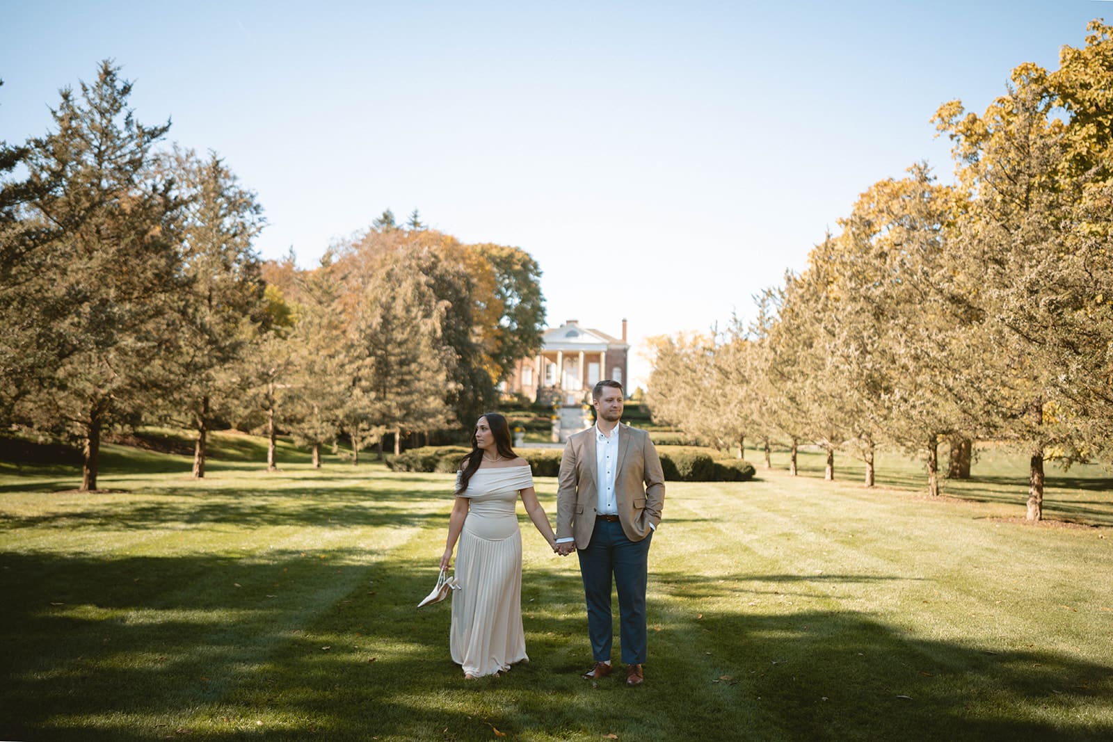 A couple taking engagement photos in the fall showing when to take engagement photos