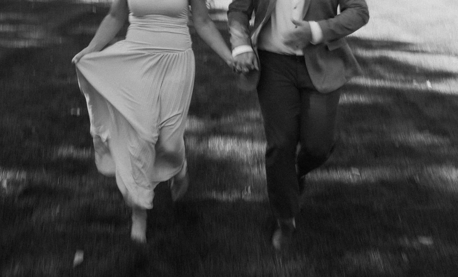 A couple running in engagement photos at the end of a blog about when to take engagement photos