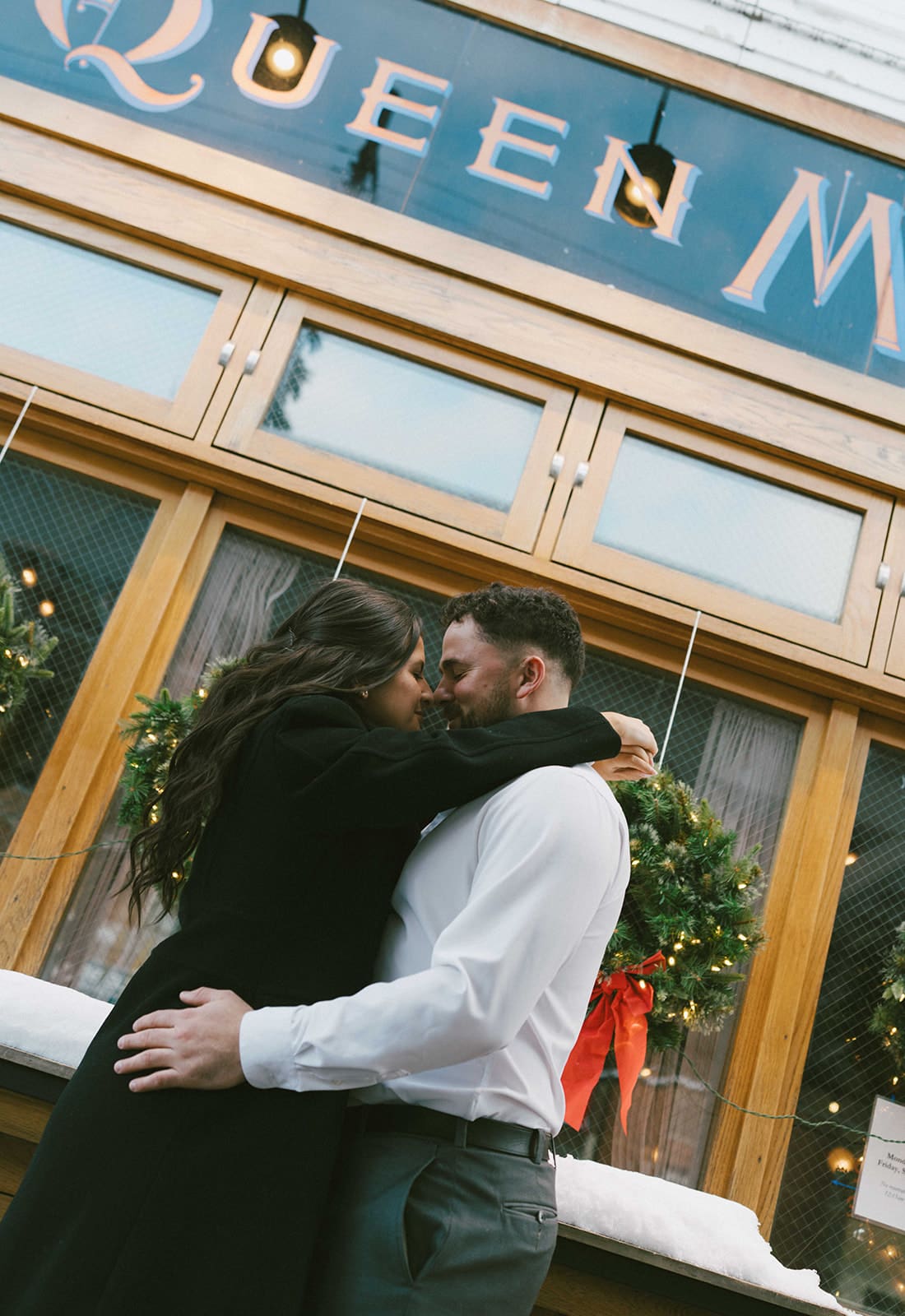 A couple taking winter engagement photos, showing when to take engagement photos