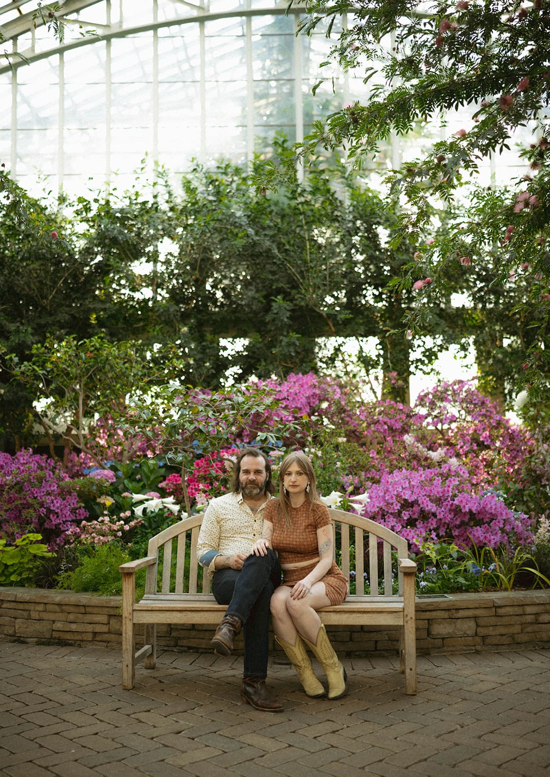 A couple posing for spring engagement photos, showing when to take engagement photos