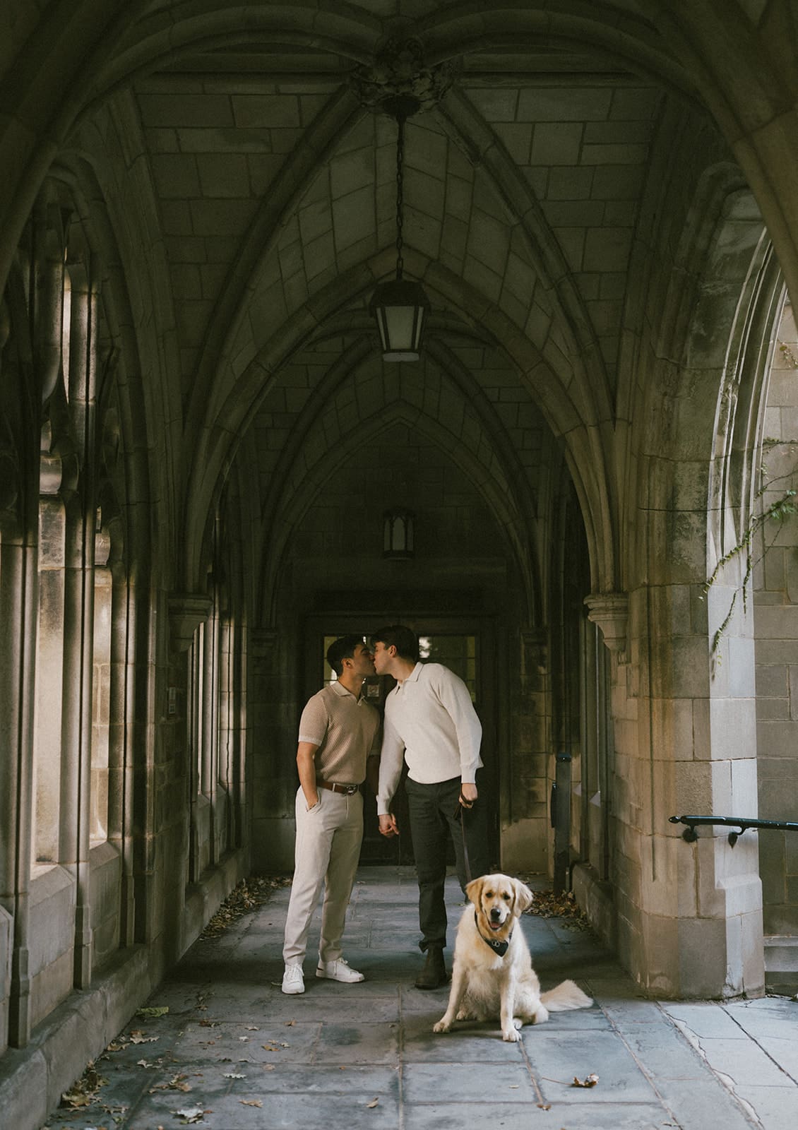 A couple posing for fall engagement photos at the university of chicago campus