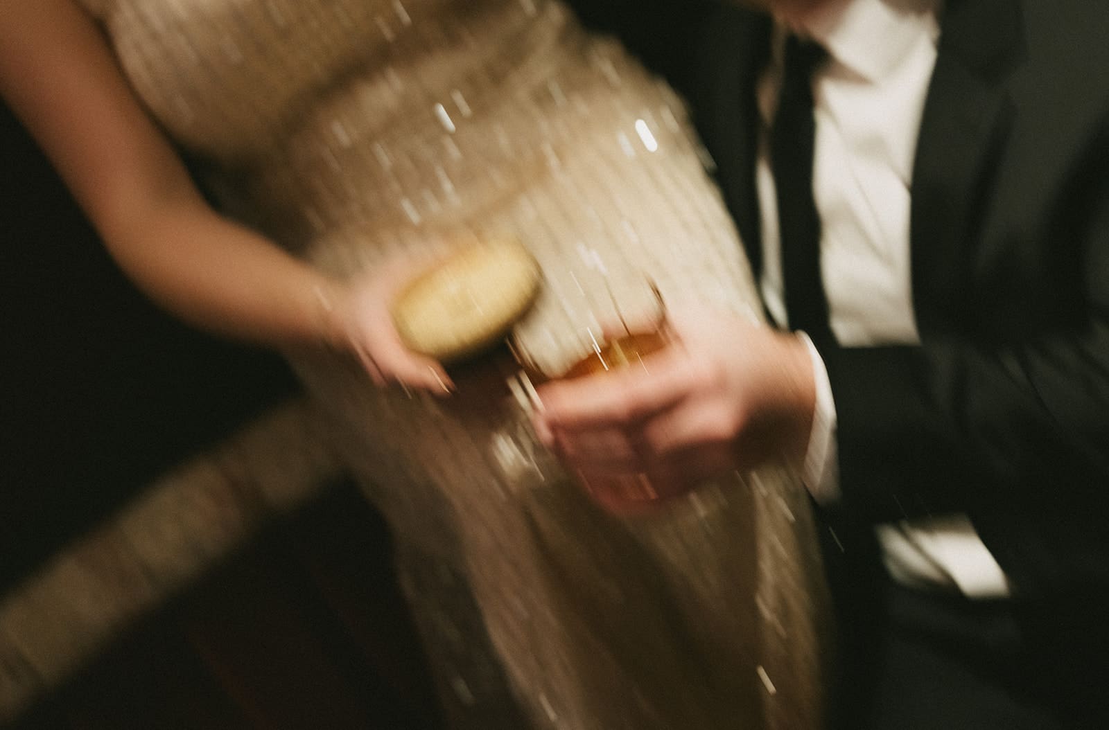 A couple holding cocktails during their winter engagement photos, showing when to take engagement photos