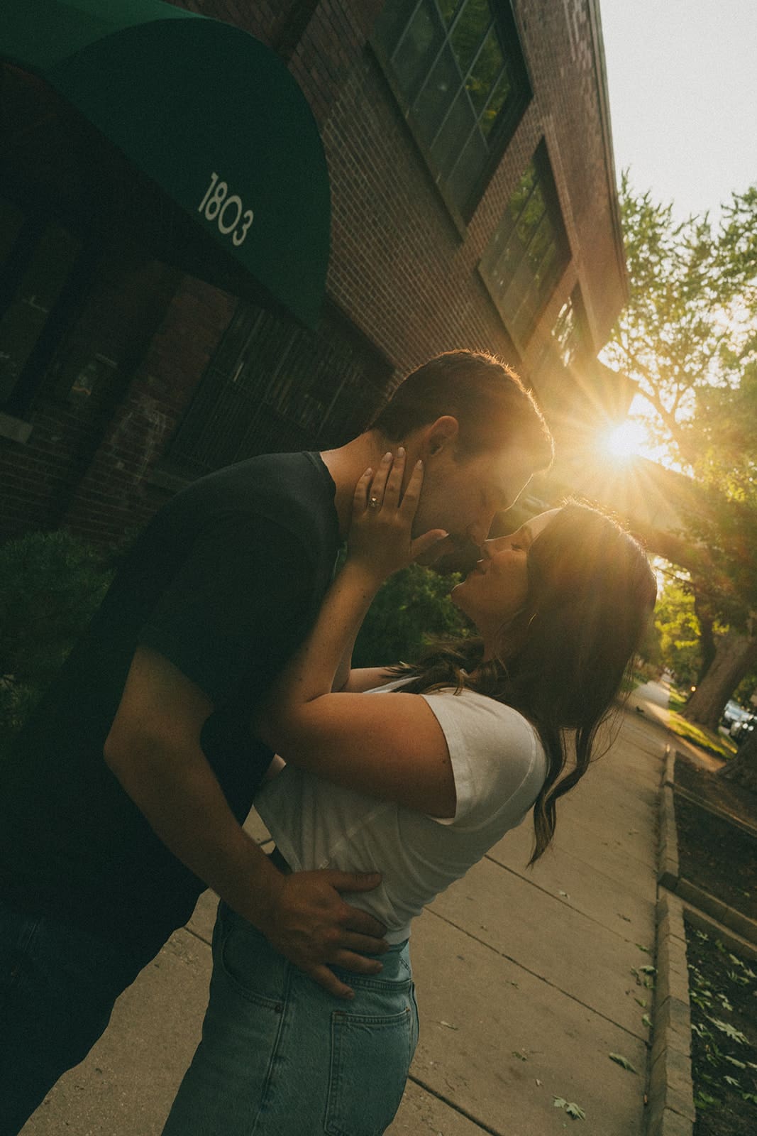 A couple taking sunset engagement photos in the summer