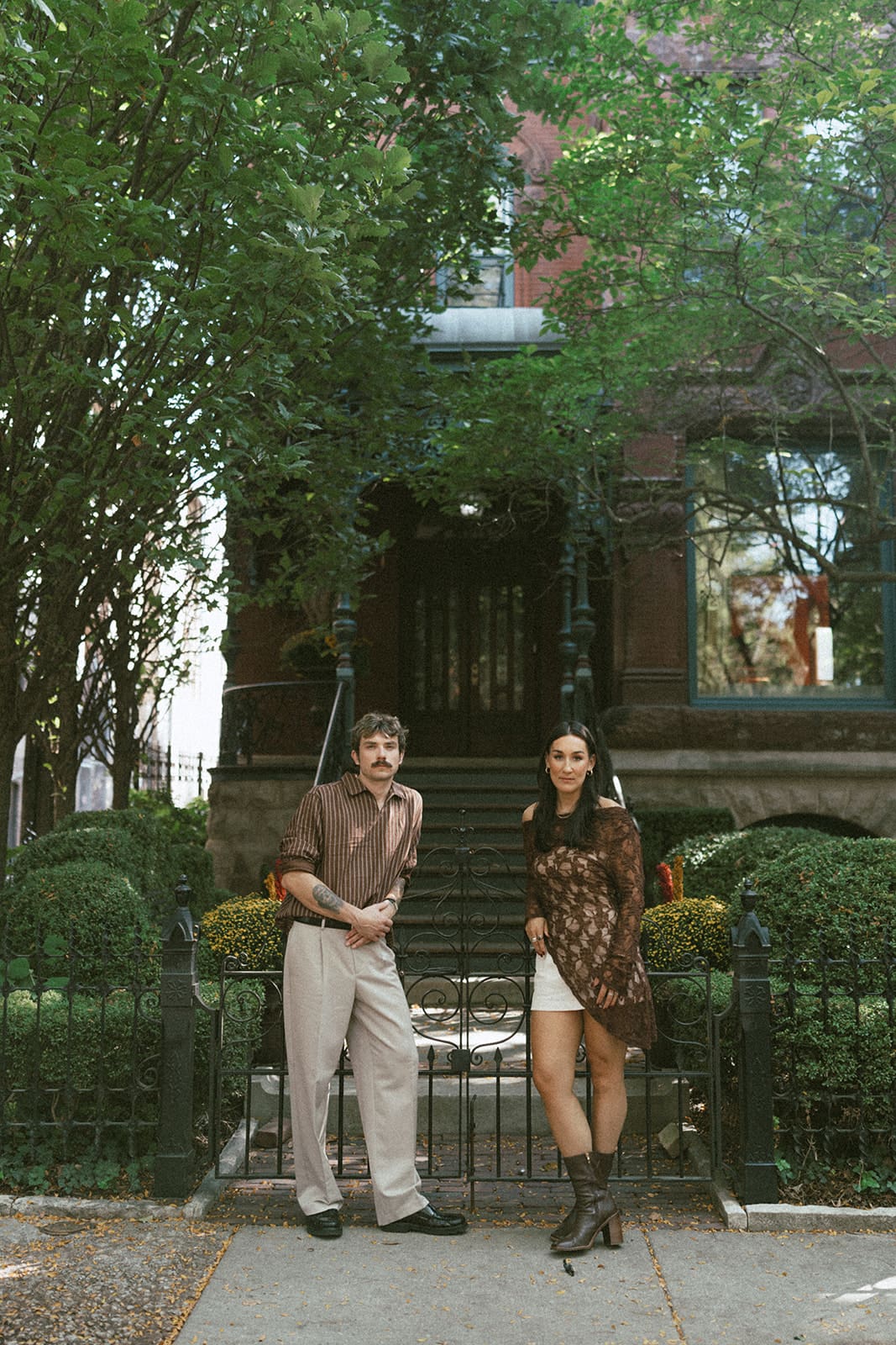 A couple posing for city engagement photos in Chicago