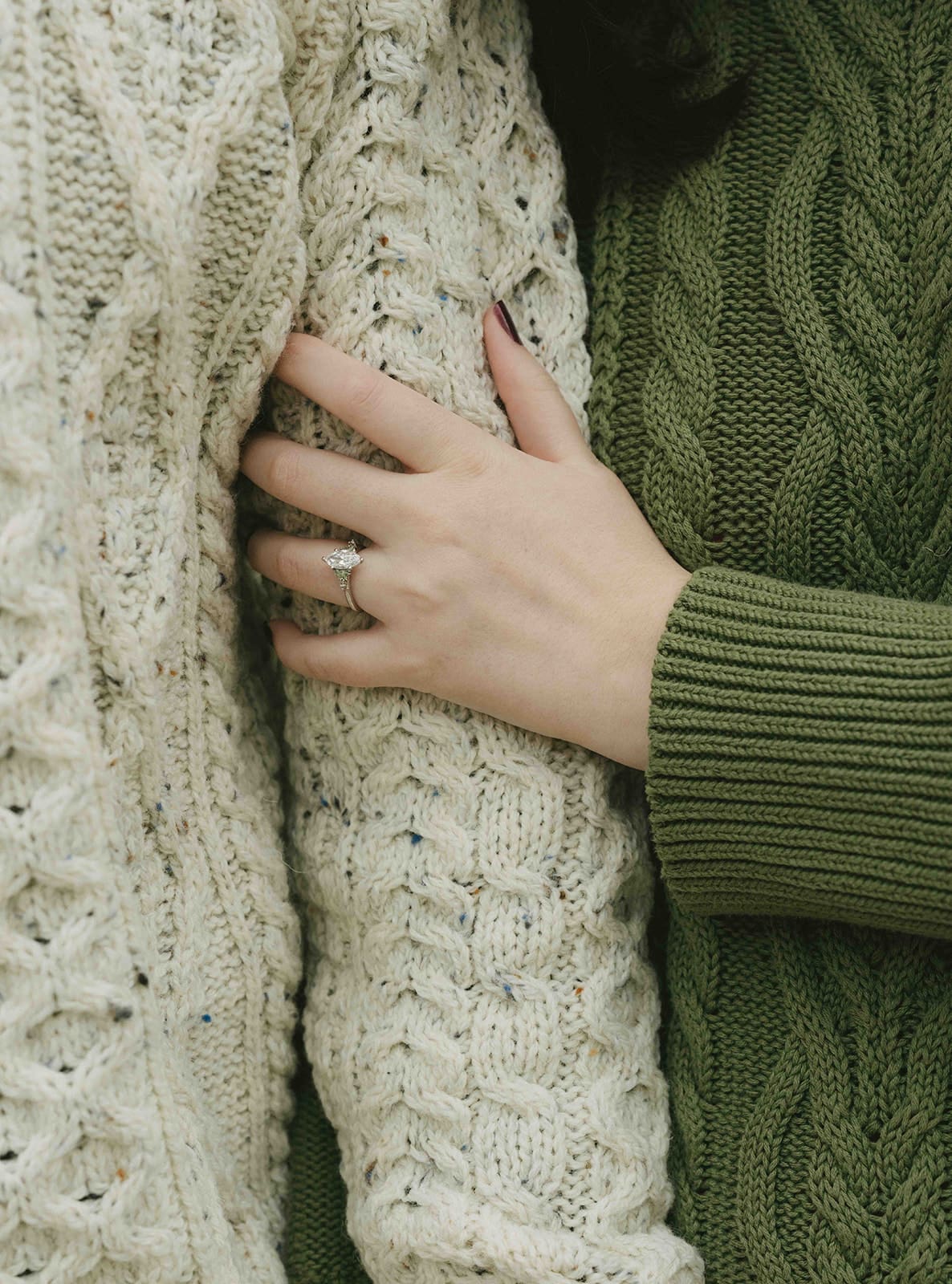 A couple wearing sweaters for fall engagement photos, when they decided when to take engagement photos