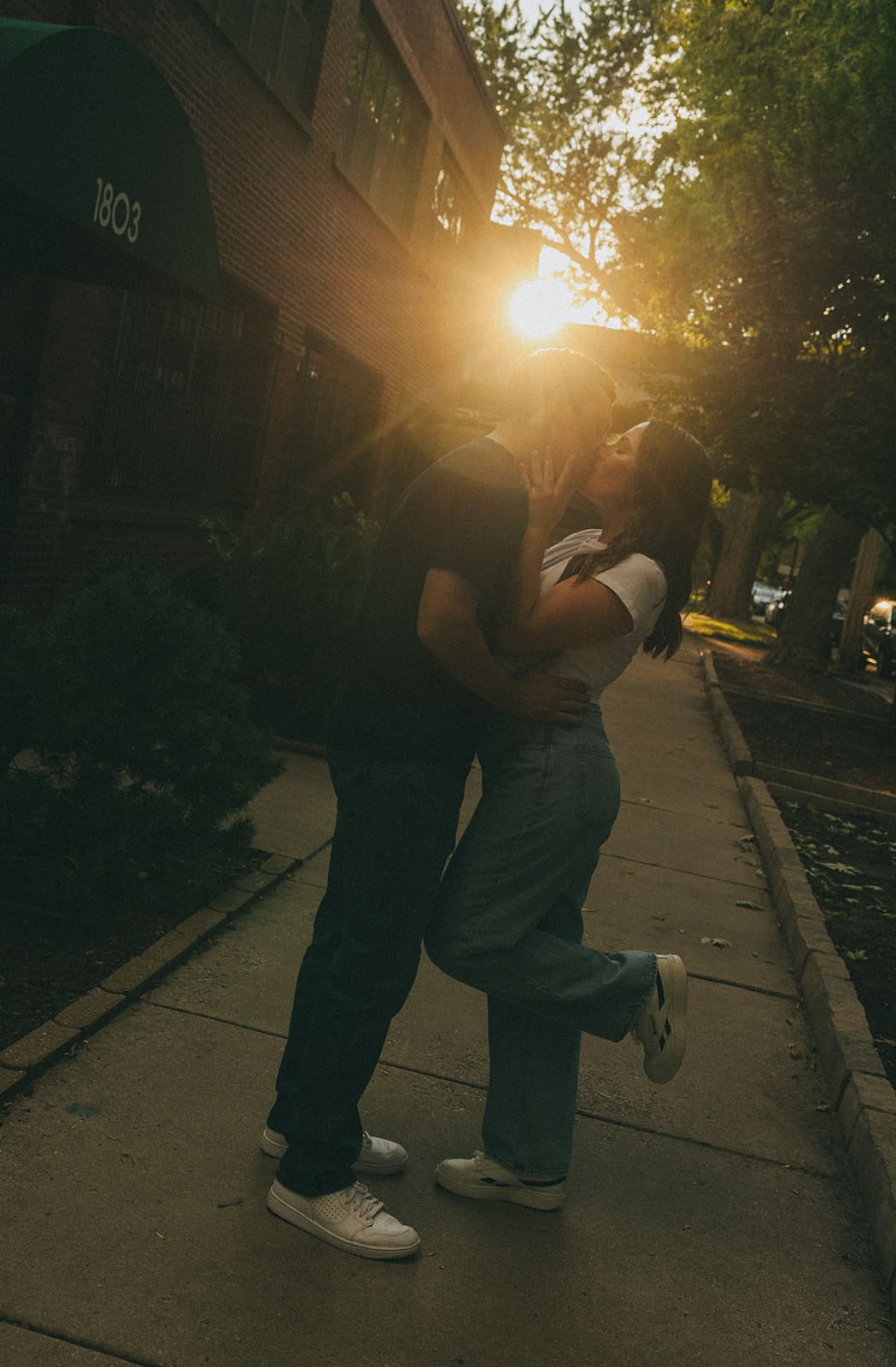 A couple taking sunset engagement photos in the summer