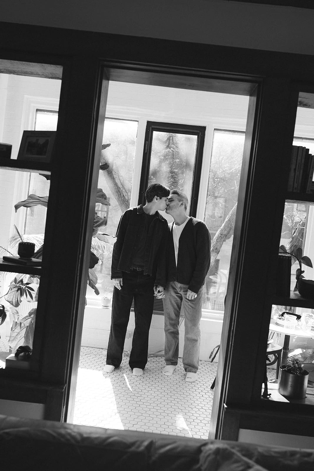 A couple taking at-home engagement photos in the winter, showing when to take engagement photos