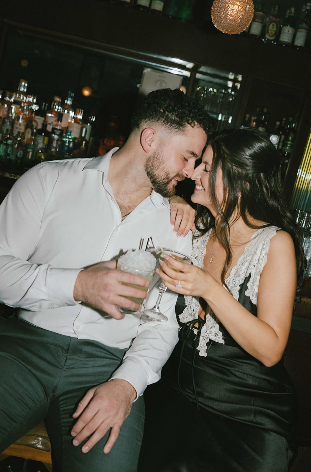A couple taking bar engagement photos, showing when to take engagement photos