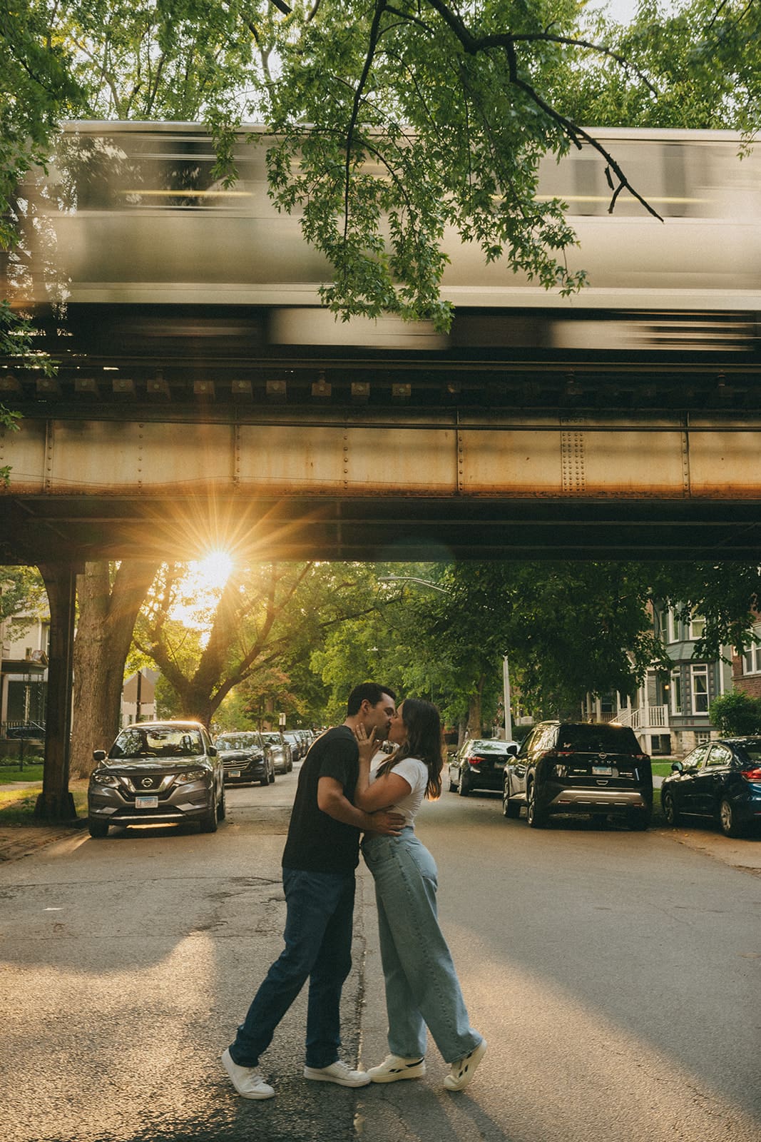 A couple taking sunset engagement photos in the summer