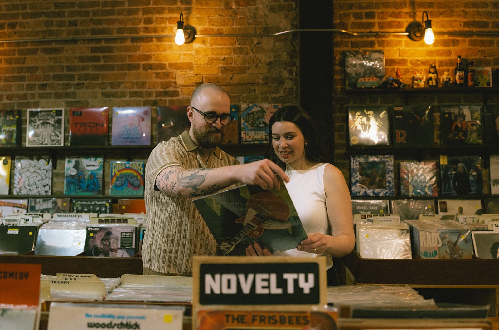 A couple who chose a record store as their engagement photoshoot location