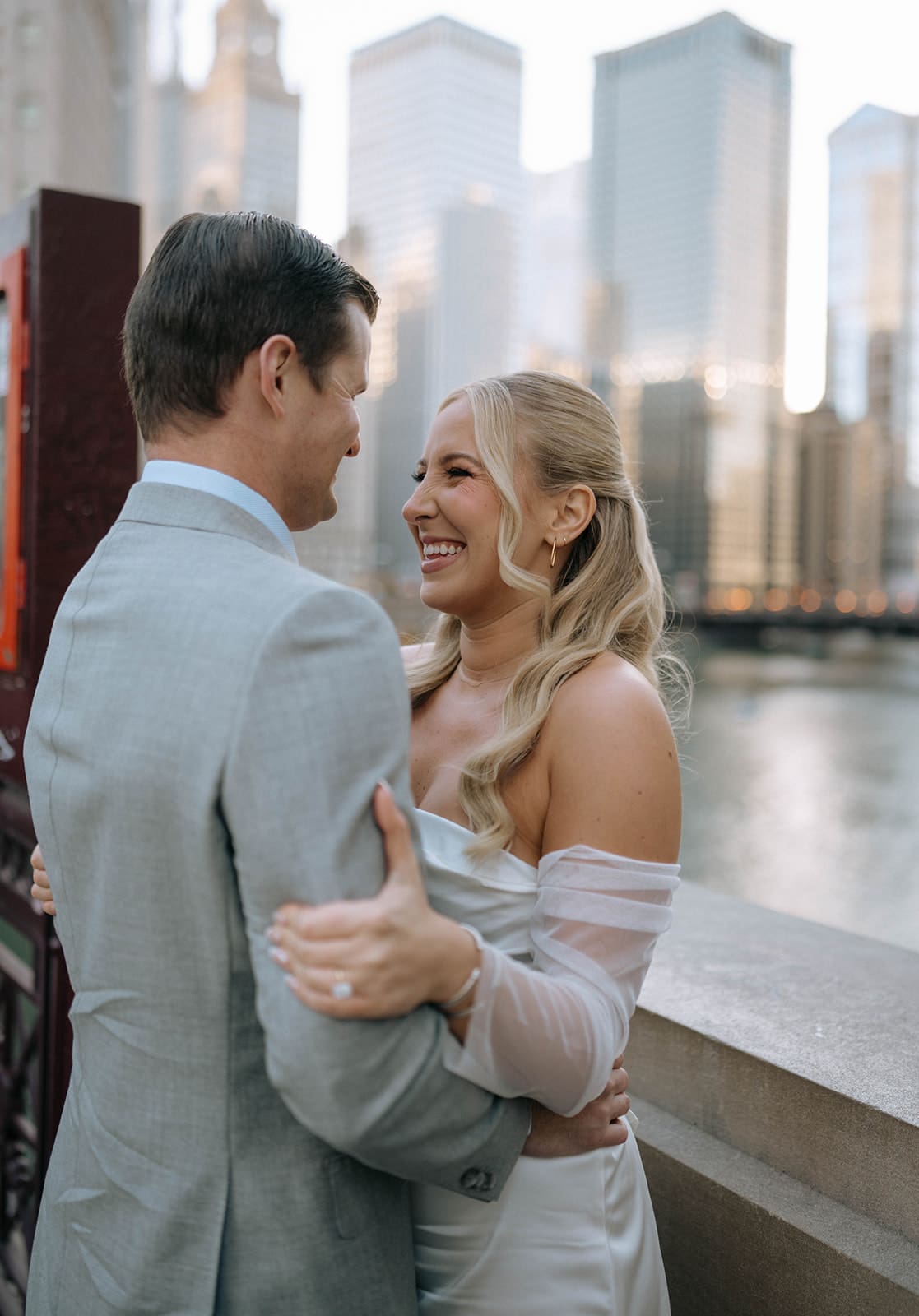 A couple posing for photos after choosing Chicago Riverwalk as their engagement photoshoot location