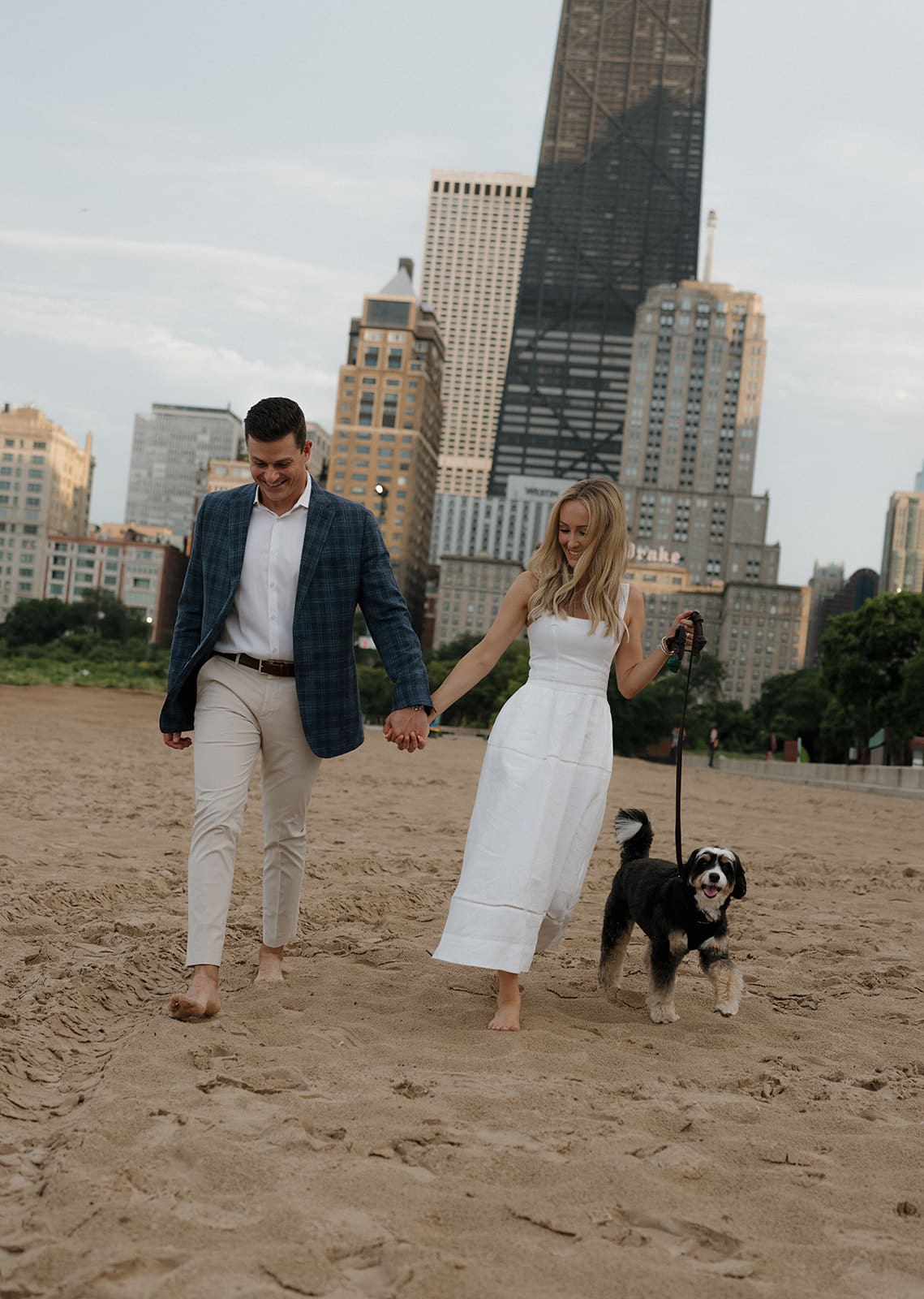 A couple on the beach as their engagement photoshoot location