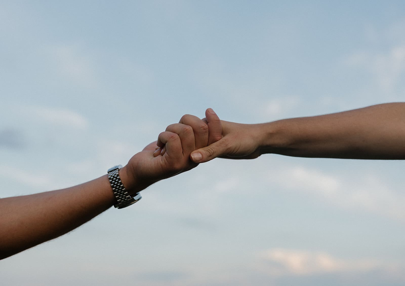 A couple holding hands during engagement photos