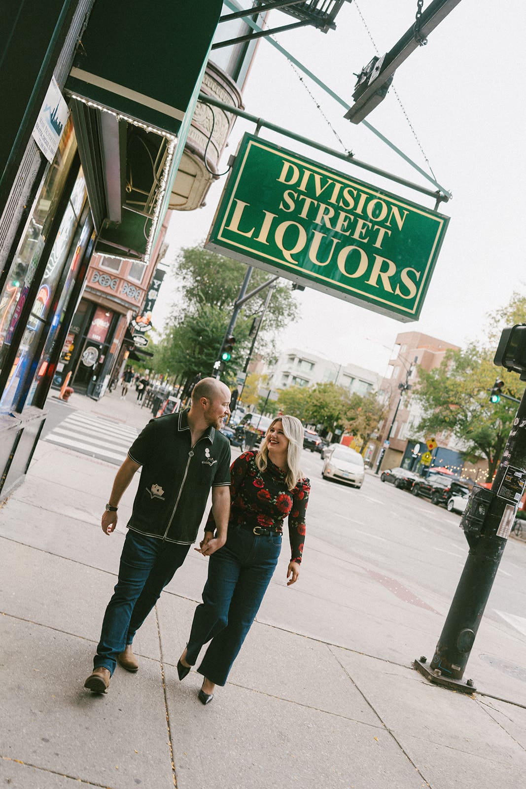 A couple walking down the street for engagement photos in Wicker PArk