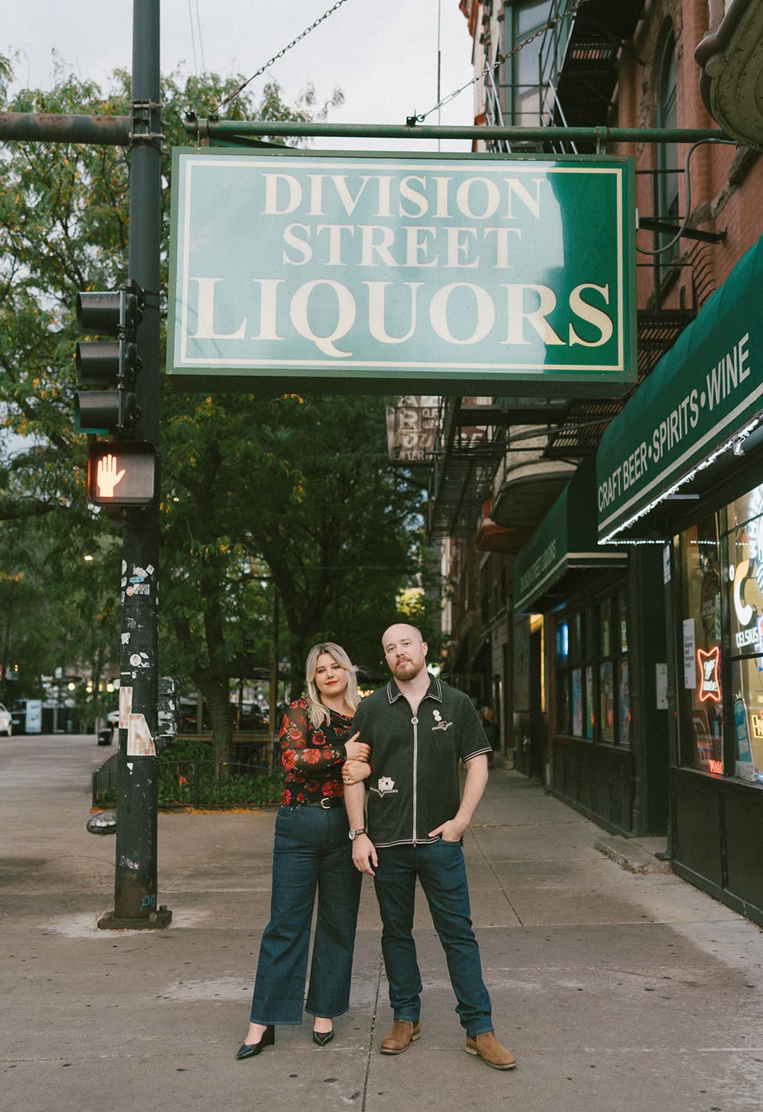 A couple walking down the street for engagement photos in Wicker PArk