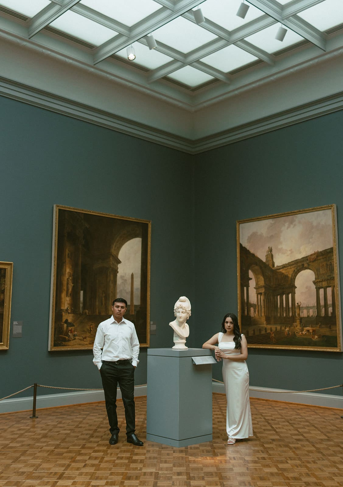 A couple in an art museum as their engagement photoshoot location