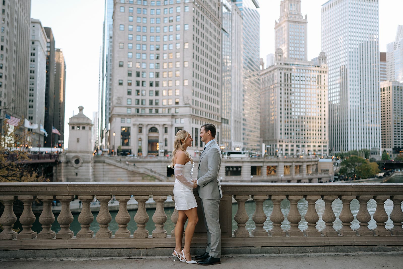 A couple posing for engagement photos on Chicago Riverwalk