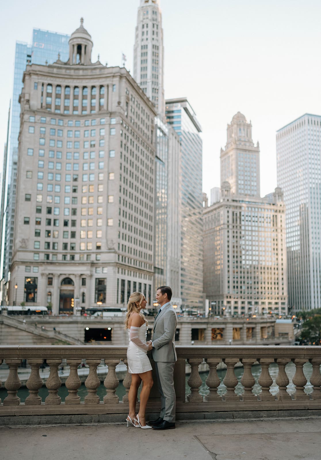 A couple posing for photos after choosing Chicago Riverwalk as their engagement photoshoot location