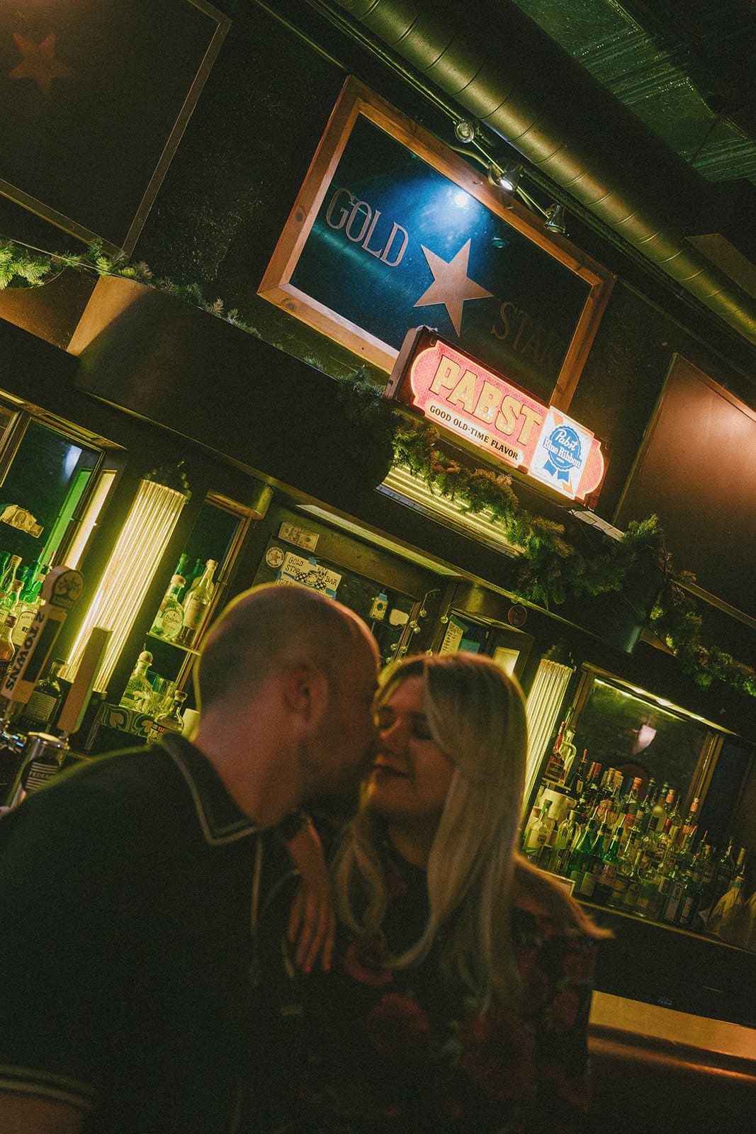A couple taking bar engagement photos
