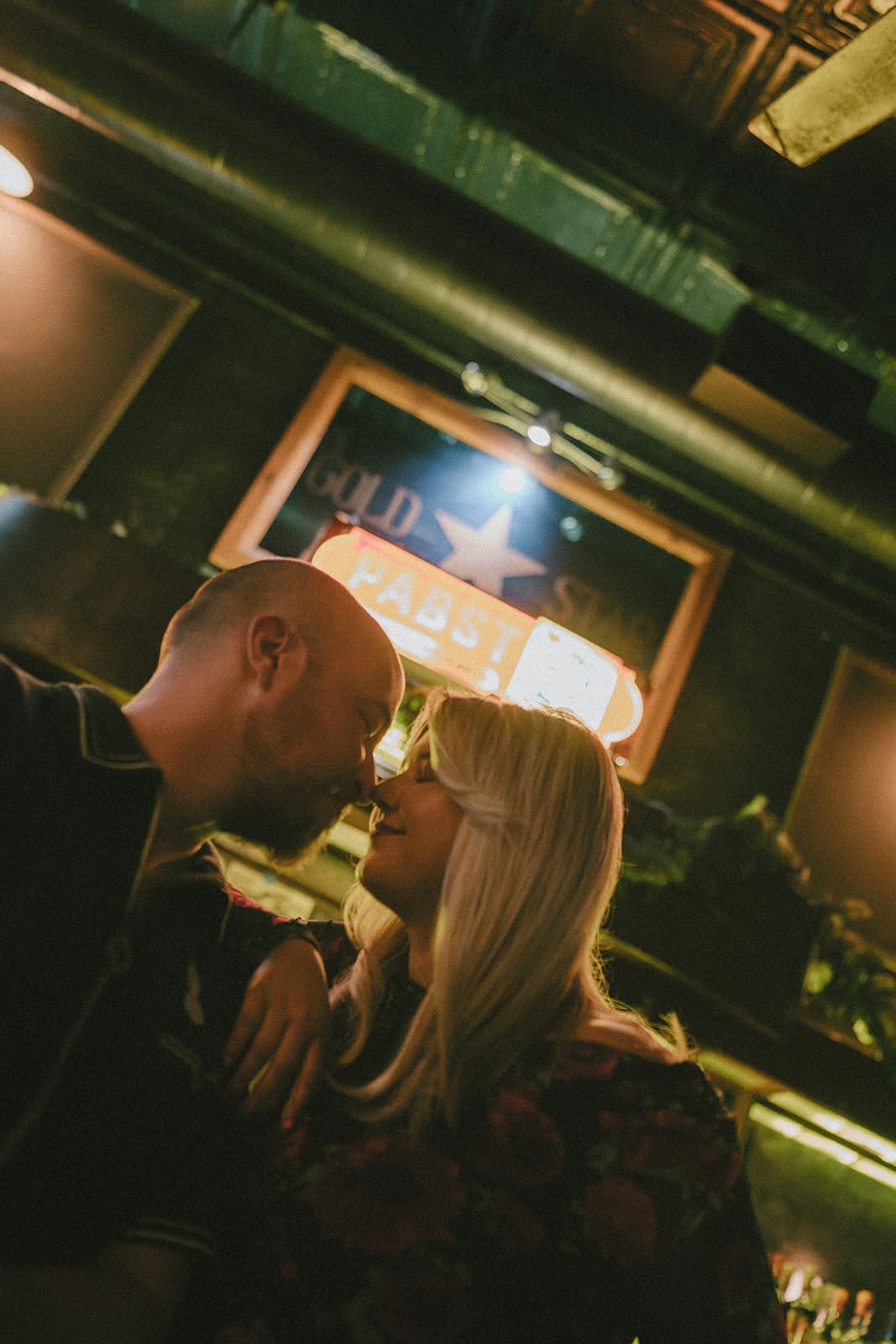 A couple taking bar engagement photos