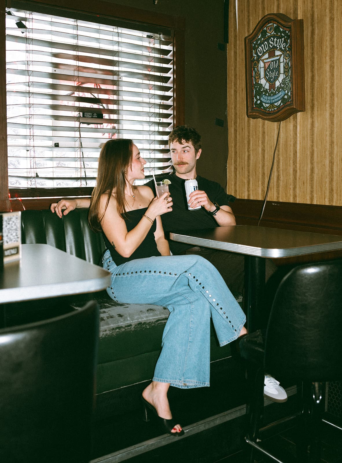 A couple in a bar for bar engagement photos