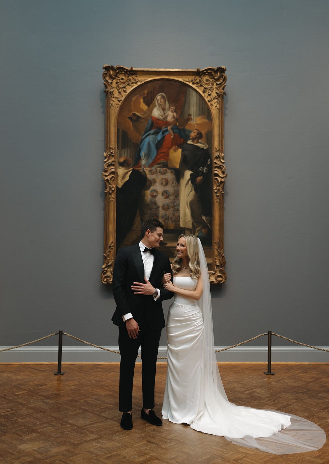 A bride and groom taking wedding photos in the Chicago art museum