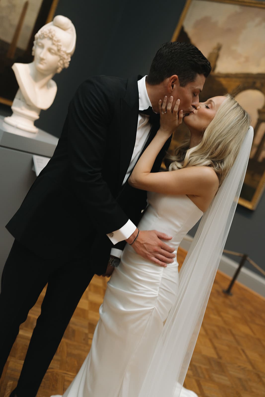 A bride and groom taking wedding photos in the Chicago art museum