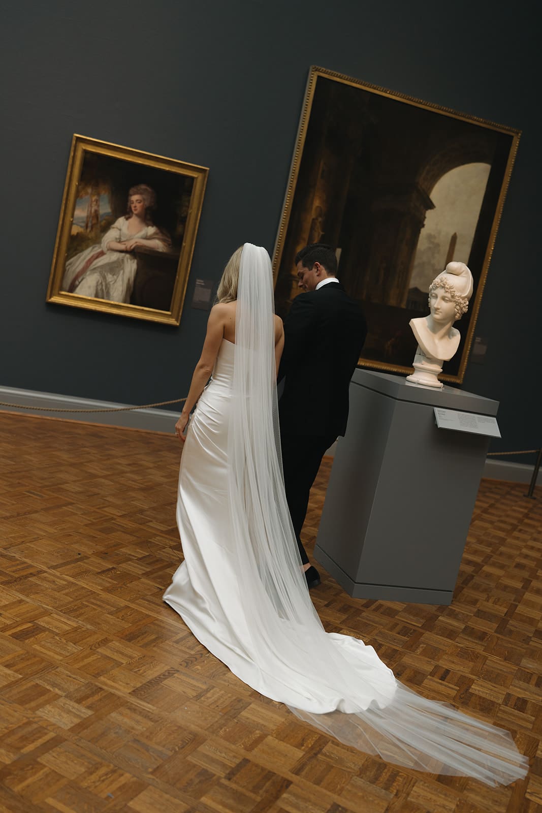 A bride and groom taking wedding photos in the Chicago art museum