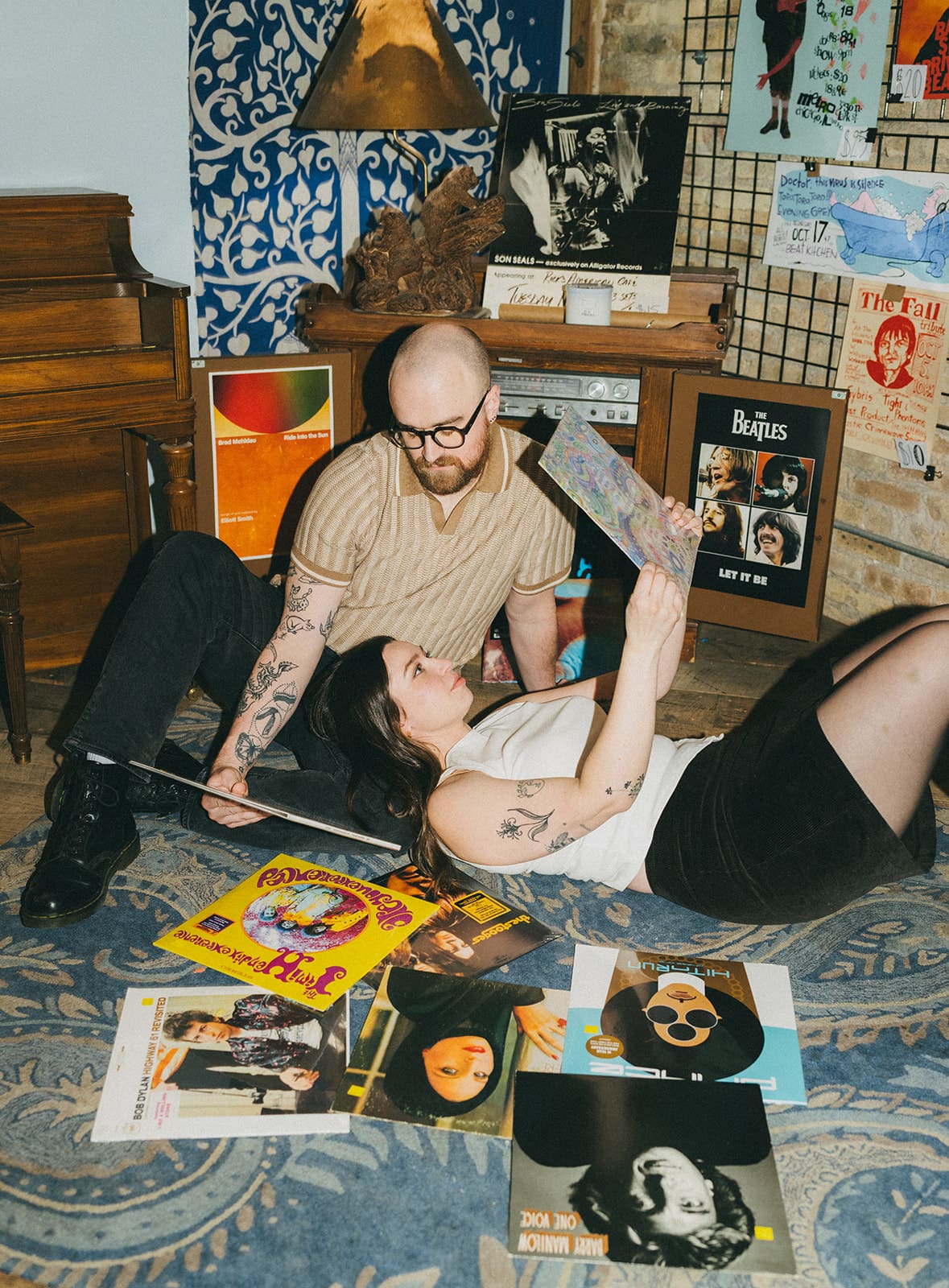 A couple taking record store engagement photos