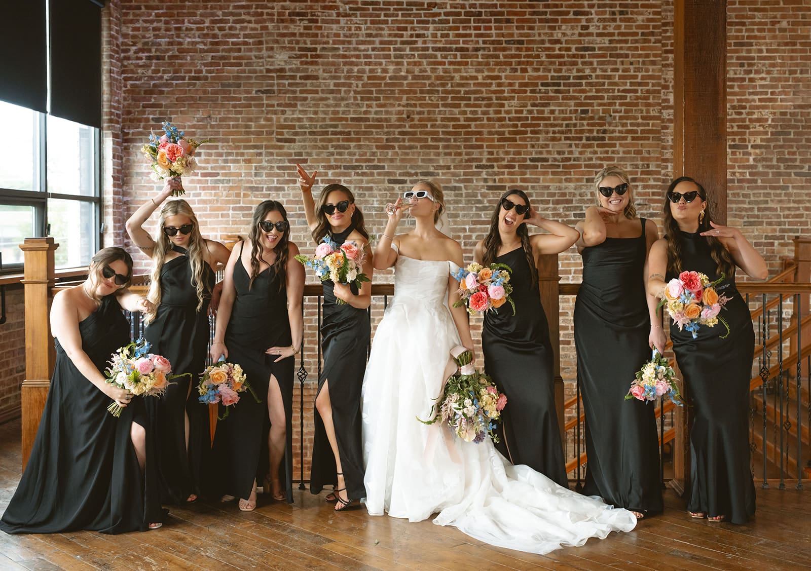 A bridal party in black bridesmaid dresses
