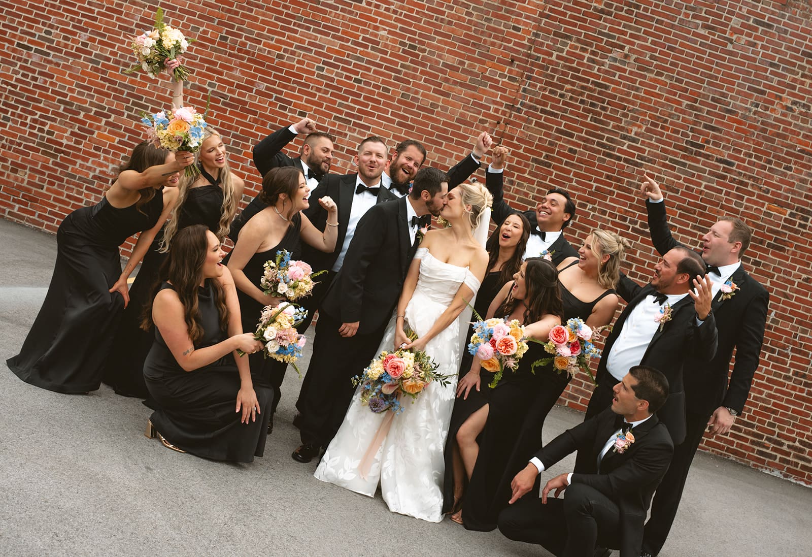 A wedding party cheering during portraits