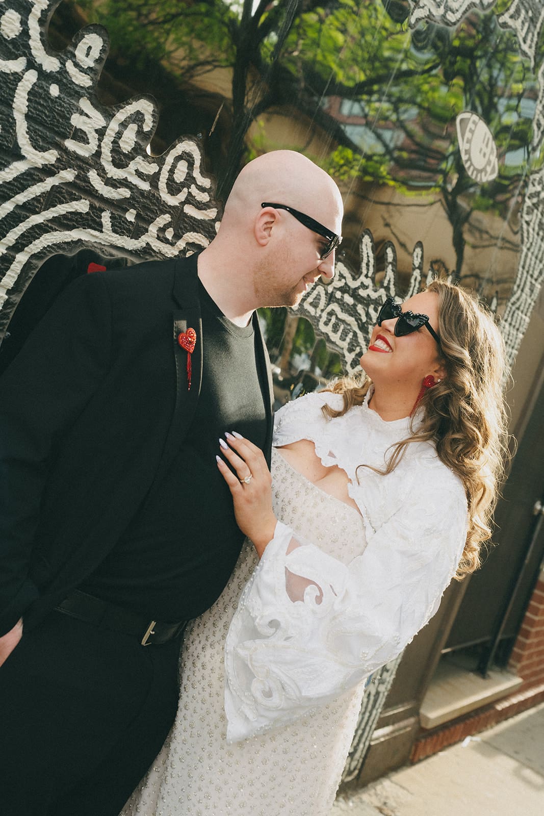 A bride and groom taking funky wedding photos on the city streets