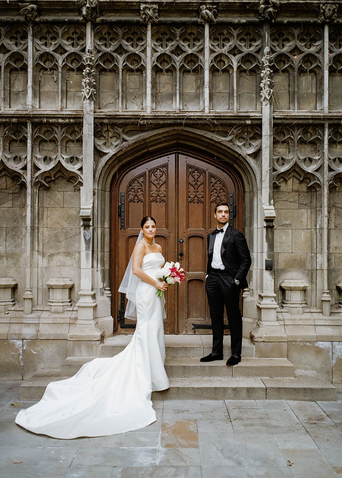 A bride and groom posing for wedding photos