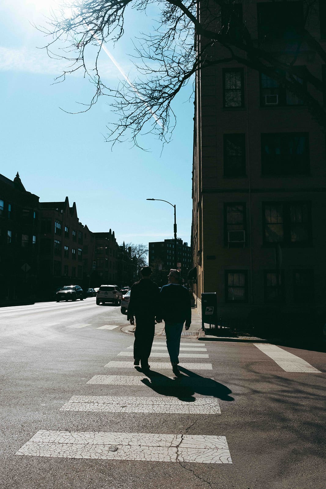 A couple walking through Lakeview Chicago for engagement photos