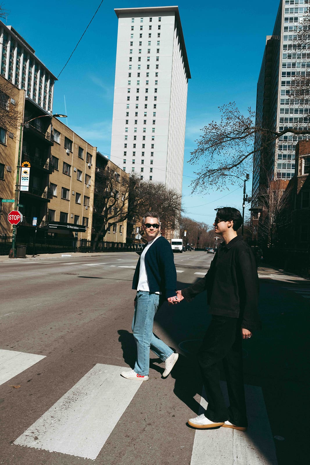 A couple walking through Lakeview Chicago for engagement photos